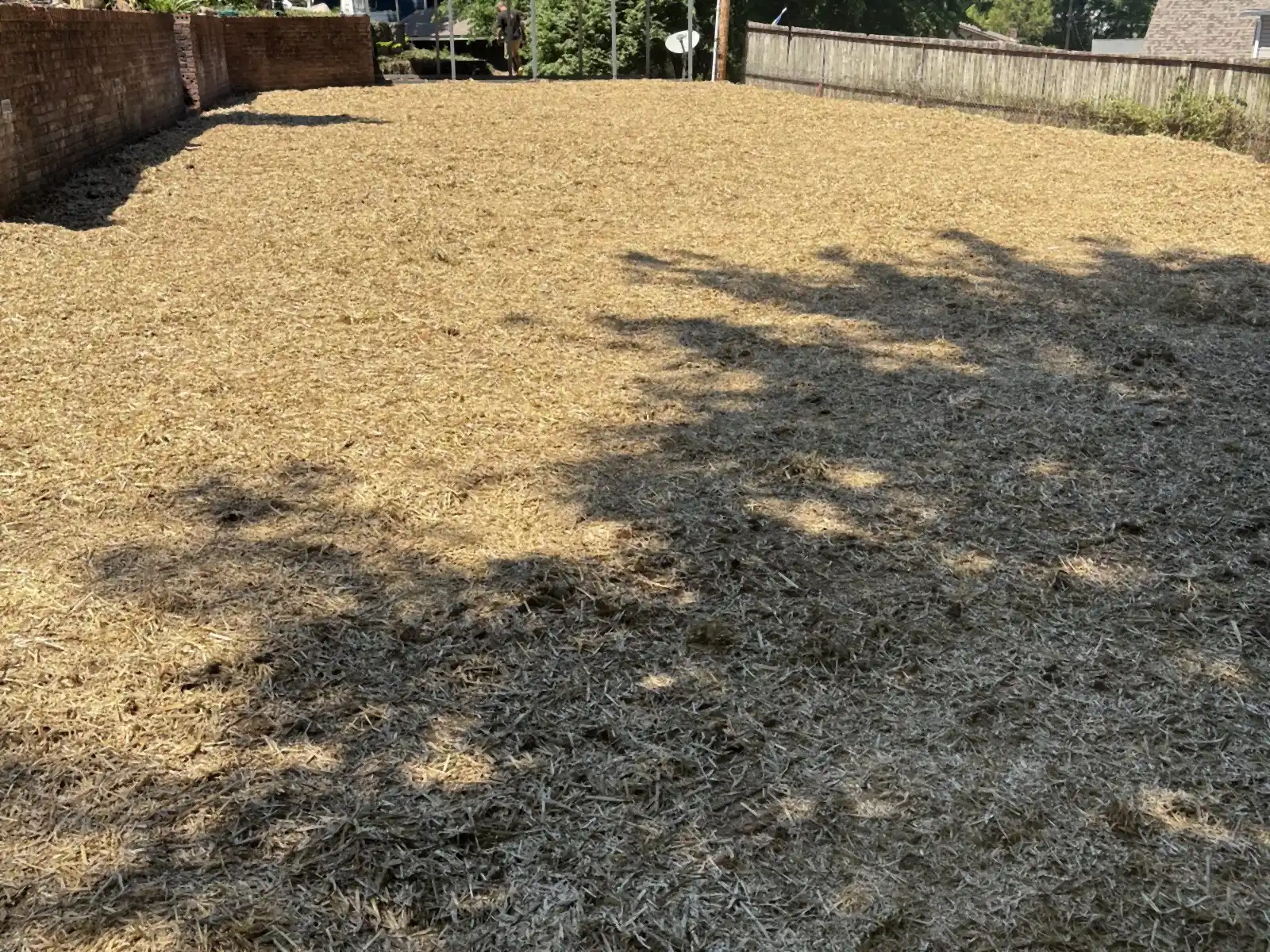 After: Mobile home before demolition and the cleared, graded pad after