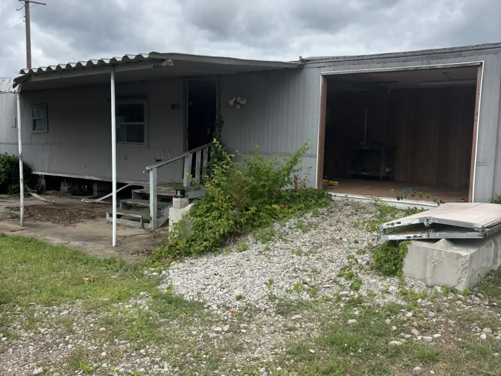 Before: Mobile home before demolition and the cleared, graded pad after