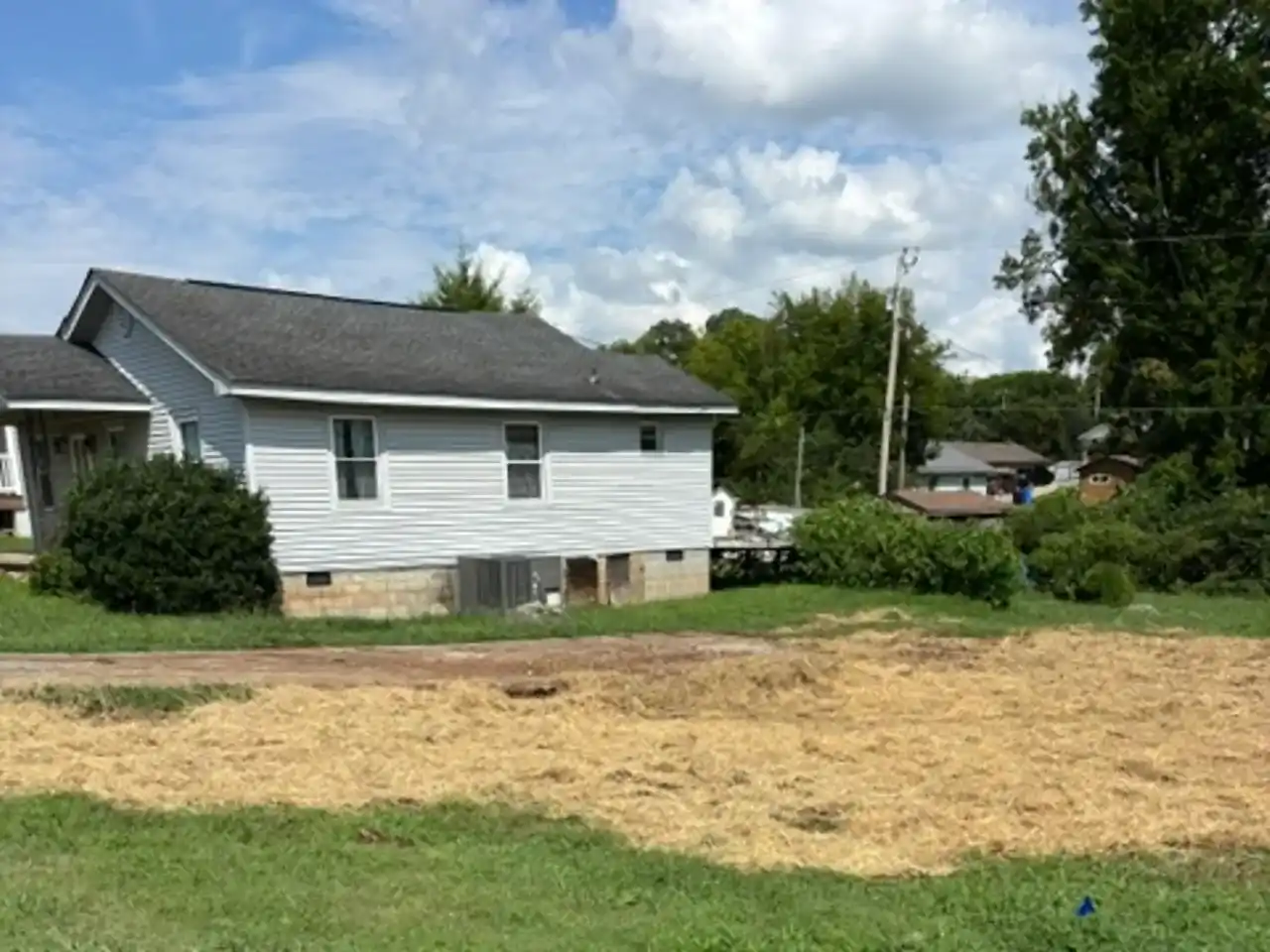 Graded lot covered with straw and seed after a demolition cleanup, R&G Land Clearing