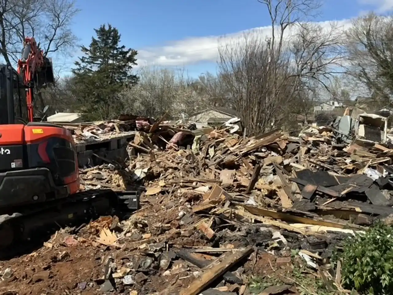 Excavator loading a large pile of demolition debris for haul-off, R&G Land Clearing