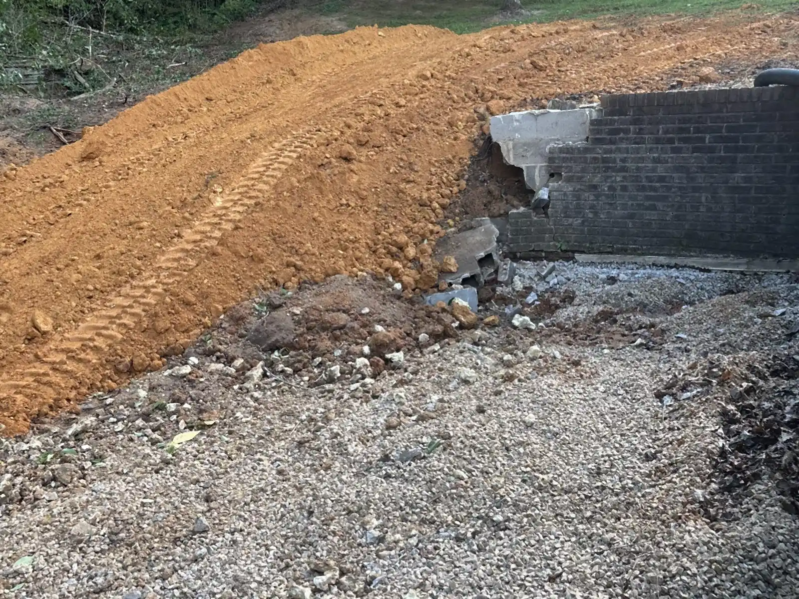 Freshly cut dirt bank and gravel on a graded site