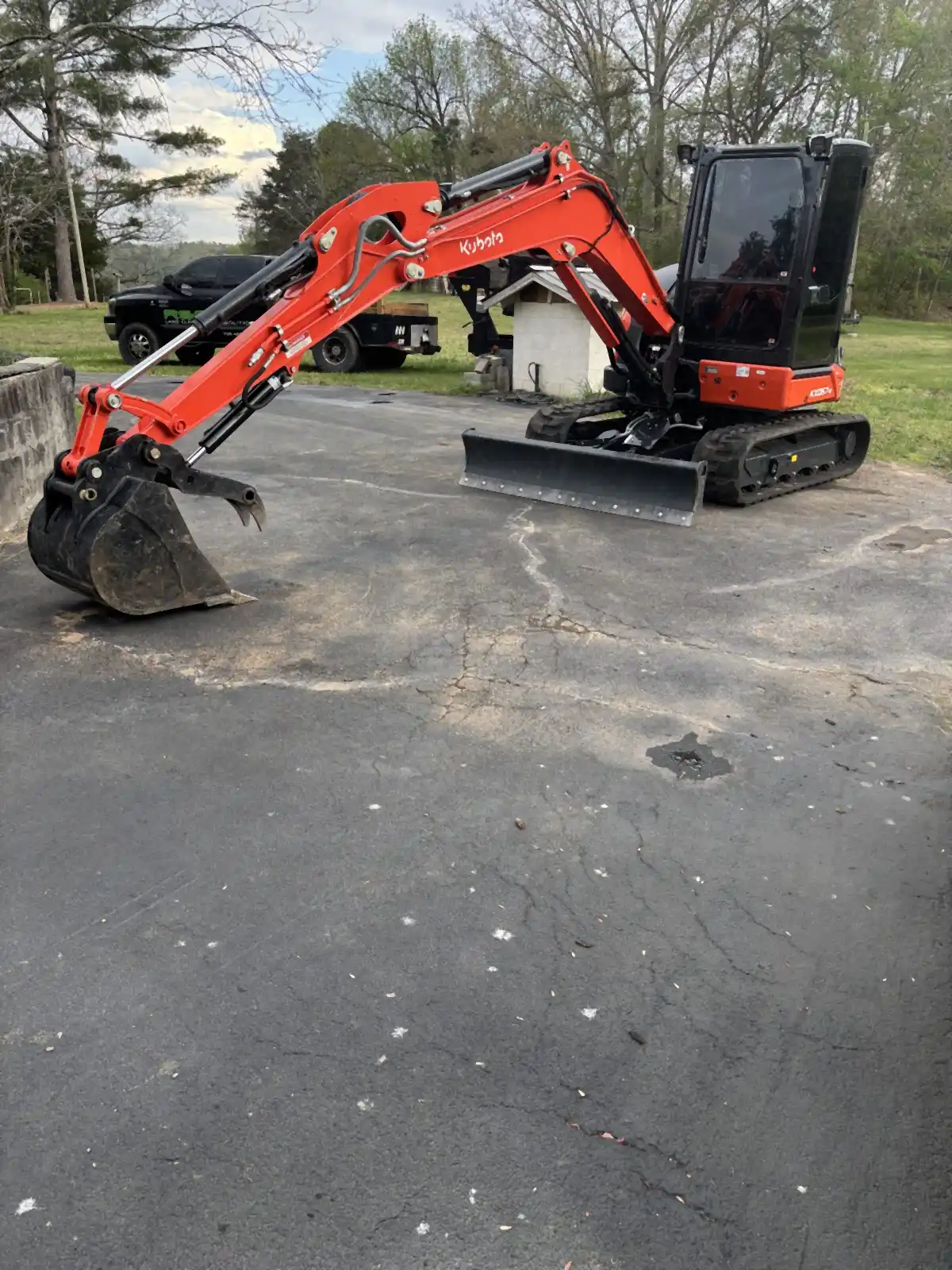 R&G Land Clearing's Kubota excavator with the bucket raised