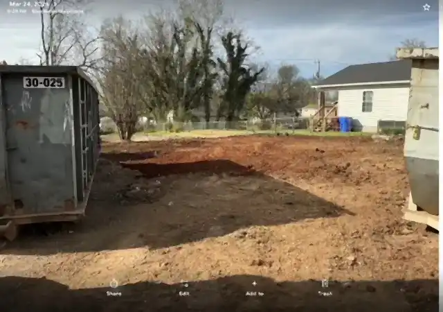 Excavated building pad with a roll-off dumpster, R&G Land Clearing