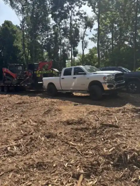 Cleared lot with work trucks