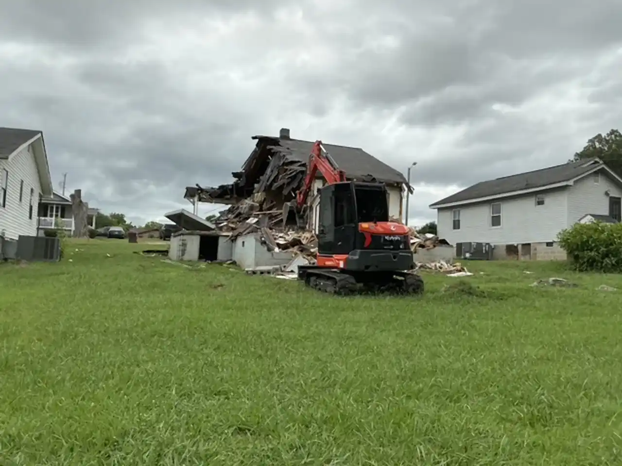 Excavator pulling the roof down on a house teardown, R&G Land Clearing