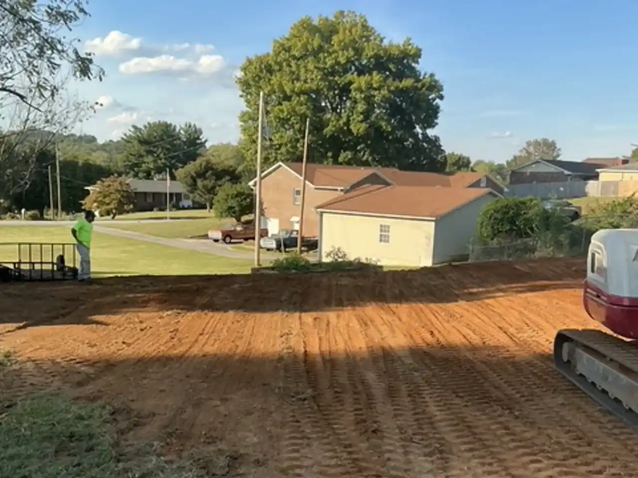 Compacted, graded fill with track marks after a pool fill-in, R&G Land Clearing