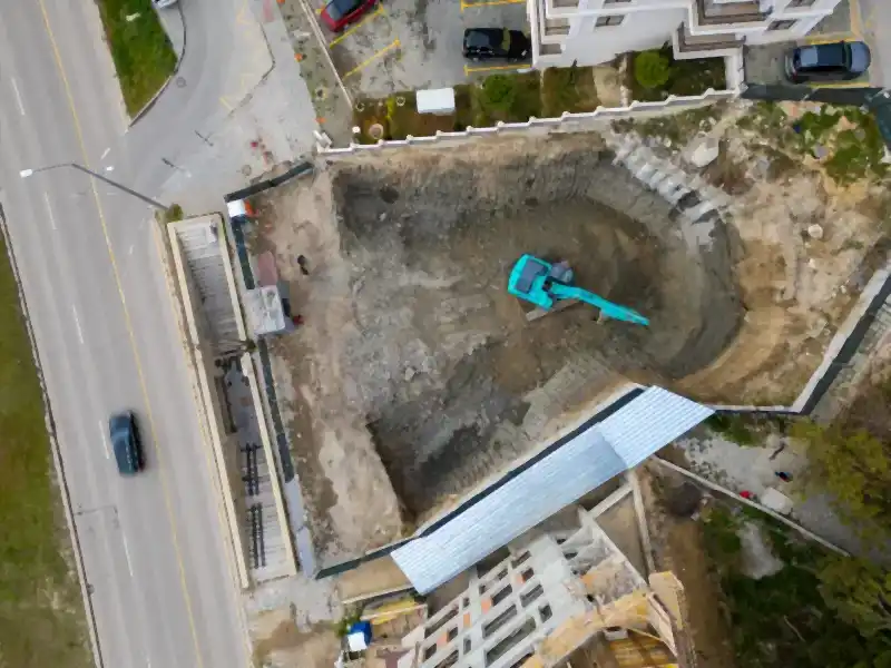Excavator digging out a residential pool in Old Fort, TN